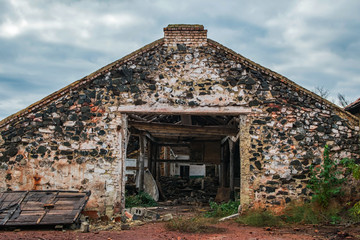 A ruined building. Wide doorway. Brick wall