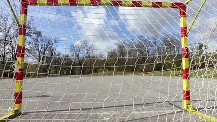 View of empty soccer and handball center court and goal with net