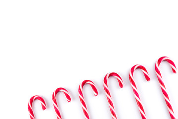 Red white striped candy canes, white background