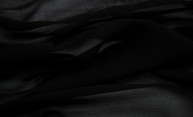 a delicate faux silk fabric in black color lined with soft folds