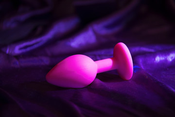 Silicone dildo anal Sex toy on a purplr background.