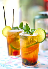 Fresh ice tea glass with ice, lemon, orange, ice tea, peach, straw, relax, fruit piece