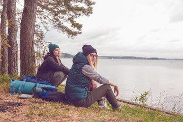 Young traveler women resting during traveling near the lake