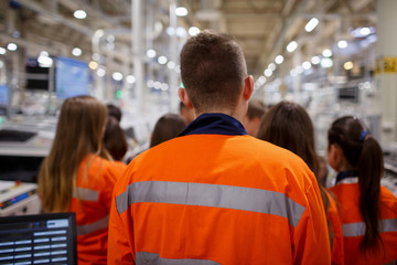Company workers in orange uniforms