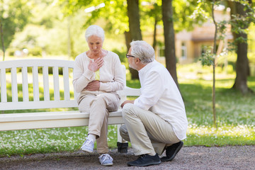 senior woman feeling sick at summer park