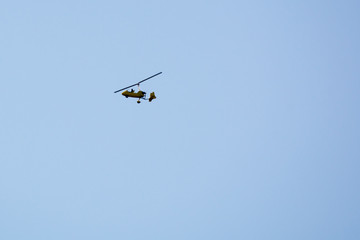 Fototapeta na wymiar Gyrocopter flying in the sky