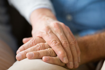 close up of senior couple holding hands - obrazy, fototapety, plakaty