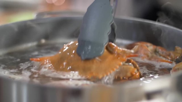 Dunking freshly boiled crabs in water