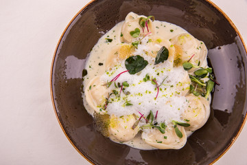 Pike Dumplings with creamy sauce from a pike, is served with champagne sauce and pike caviar