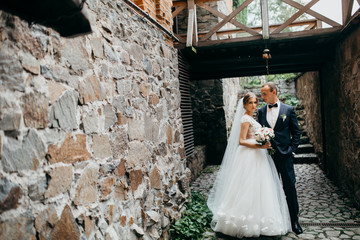Wedding couple are walking in the beautiful castle 