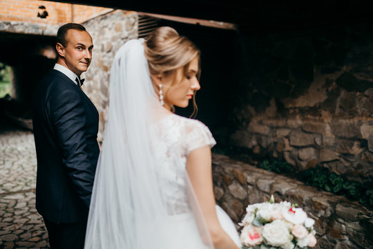 Wedding couple are walking in the beautiful castle 