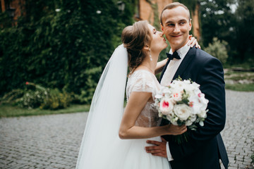 Wedding couple are walking in the beautiful castle 