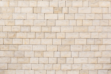 the wall is tiled with natural stone