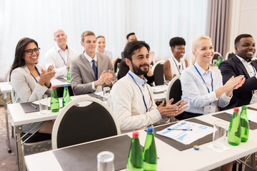 people applauding at business conference
