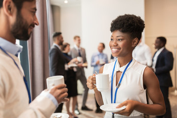 business people with conference badges and coffee