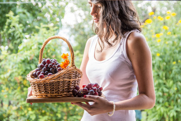 Young woman with grapes