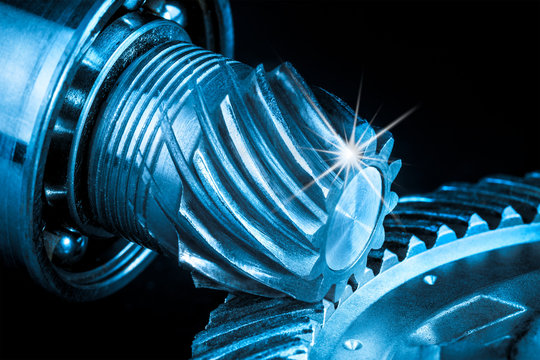Beautiful close-up of steel gear mechanism. Abstract industrial background with cogwheels in blue and black color.