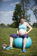 Pregnant woman excercises with gymnastic ball