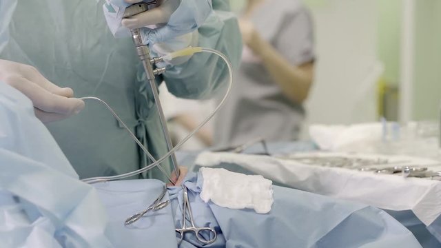 close-up. the hands of the neurosurgeon performs a craniotomy through the nose endoscopically. inspection of the nasal cavities