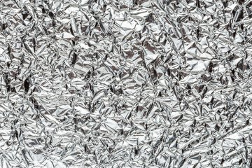 Crumpled shiny metal foil texture or background