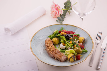 Nisuaz. Tataki from a tuna, fresh vegetables, olives, potato and greens