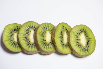 cut kiwi slices on white background