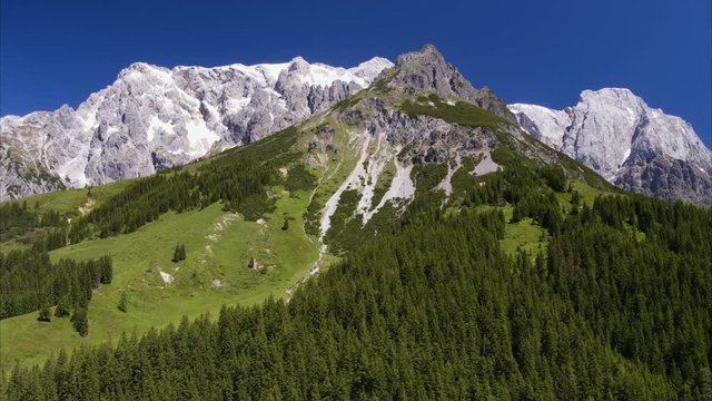 Wide aerial panning shot of trees on mountain range / HInterthal, Austria