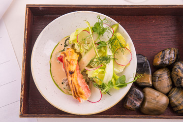 Zapecheny crabmeat with mushrooms fricassee, is served with vegetables 