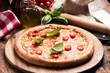 Delicious Pizza with cherry tomato on wooden table