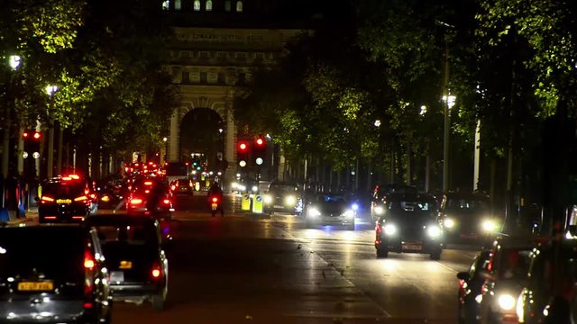 Traffic drives down The Mall towards Admiralty Arch and Trafalgar square at night