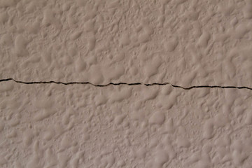Cracked wall or cracked floor texture. White Wall Texture. Old Cracked Plastered Brick Wall Background.