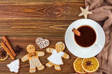 The Christmas or New Year background - Homemade christmas gingerbreads with a cup of coffee on wooden boards