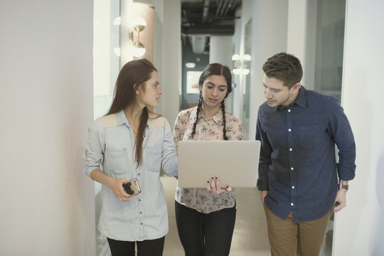 Young professionals working on laptop in office