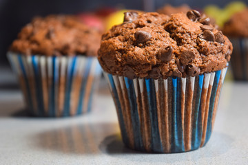 chocolate muffins, homemade cakes in the winter evening