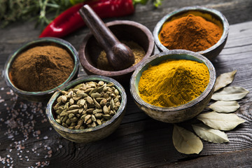 Herbs and spices on a wooden background 