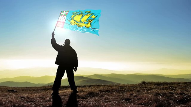 Successful silhouette man winner waving Pierre and Miquelon flag on top of the mountain peak, Cinemagraph LOOP background