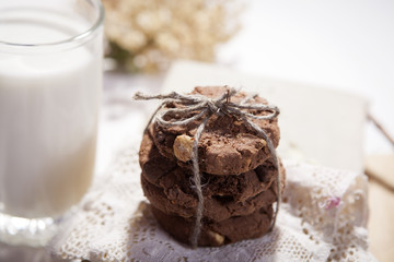 the dark chocolate biscuits with nuts on dark wooden background