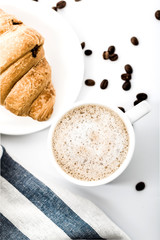 Cappuccino on a striped tablecloth. Morning coffee.