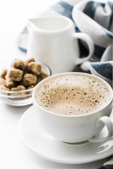 Cappuccino on a white table. Morning coffee.