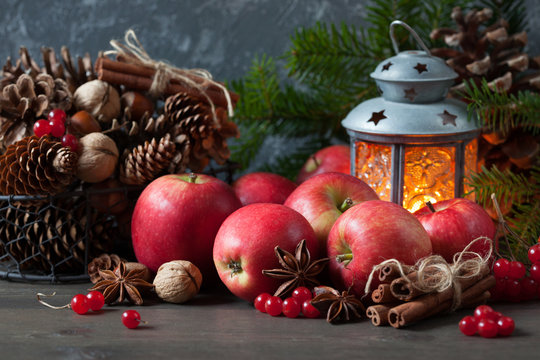 Red apples, berries, cones, nuts and a flashlight with a candle