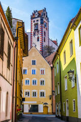 Fototapeta na wymiar Beautiful street of old houses with the tower of the High Castle, Fussen city, Germany