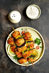 Grilled salmon kebab on a craft plate .Top view .