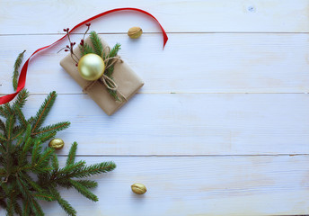 Christmas gift boxes and fir tree branch on wooden table, flat lay. Сhristmas background