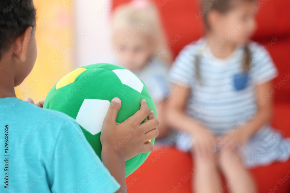 Canvas Prints little boy playing ball with friends indoor, closeup