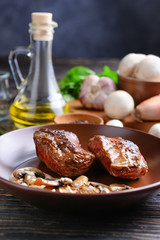 Plate with steak Diane on wooden table