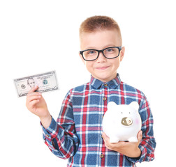 Cute little boy with piggy bank on white background