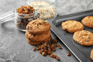 Delicious oatmeal cookies with raisins on table