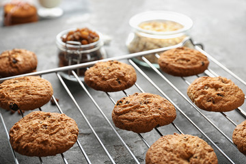 Delicious oatmeal cookies with raisins on metal grid, close up