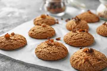 Delicious oatmeal cookies with raisins on table, close up