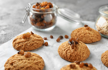 Delicious oatmeal cookies with raisins on table, close up